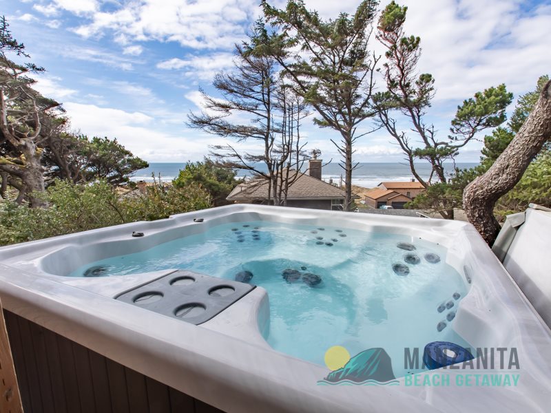 Bird’s-eye view of Manzanita Beach on the Oregon Coast, with golden sand and coastal homes surrounded by trees