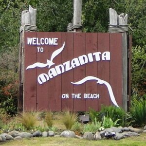 welcome to manzanita on the beach sign